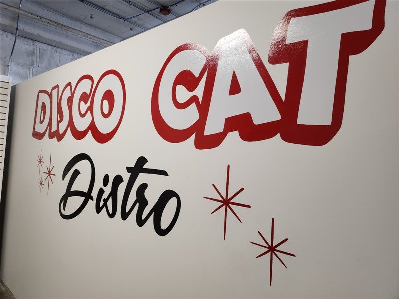 The hand-painted Disco Cat wall at the Omaha event space